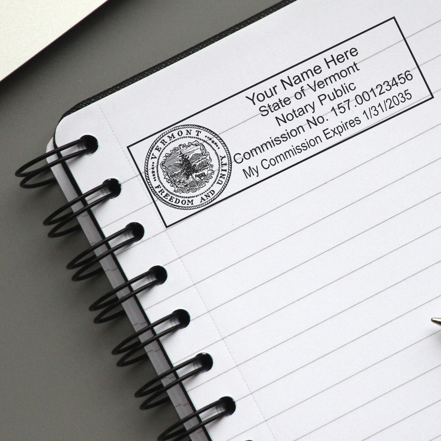 A photograph of the Wooden Handle Vermont State Seal Notary Public Stamp stamp impression reveals a vivid, professional image of the on paper.