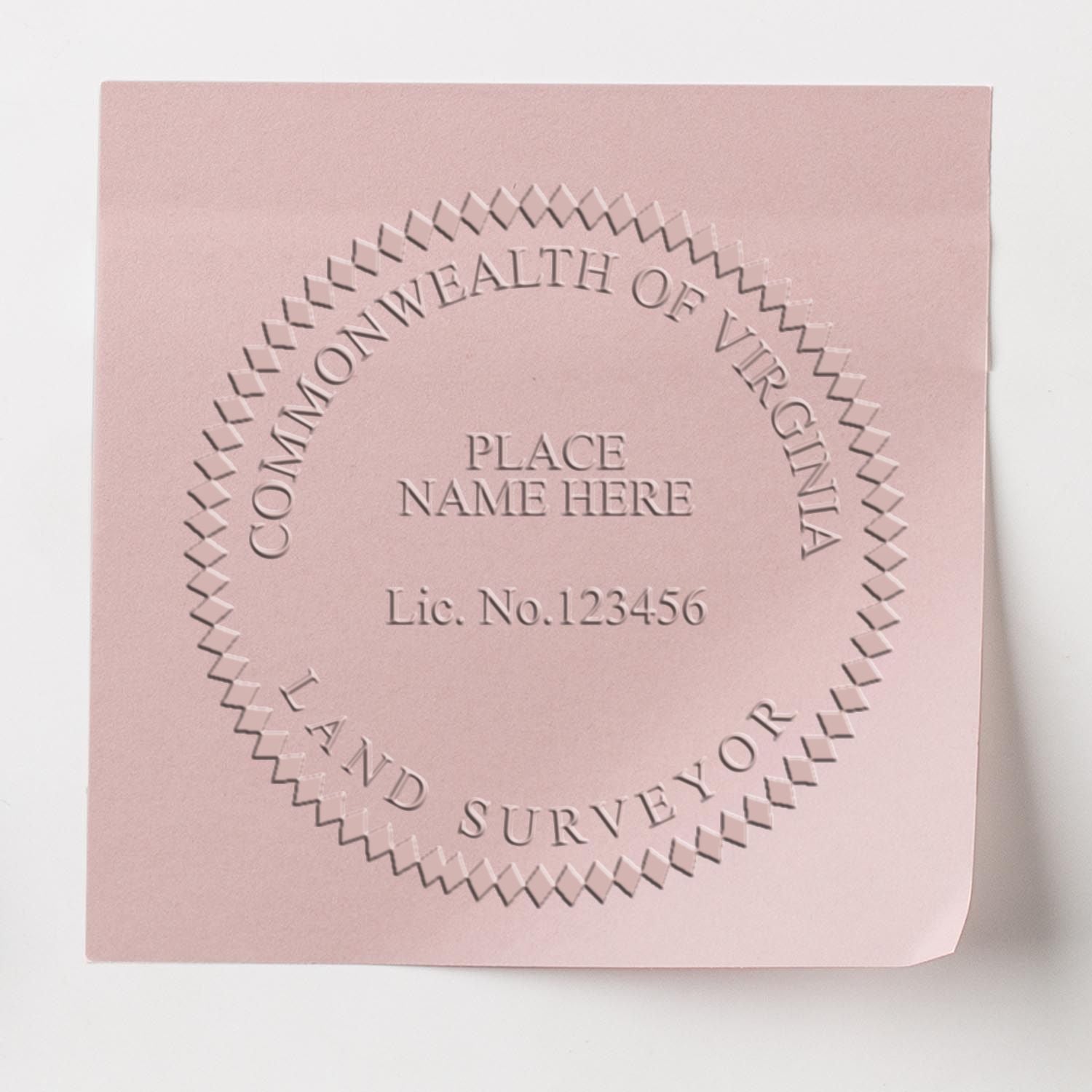 Land Surveyor Long Reach Desk Seal Embosser imprint on pink paper, displaying Commonwealth of Virginia and Land Surveyor with placeholder text.