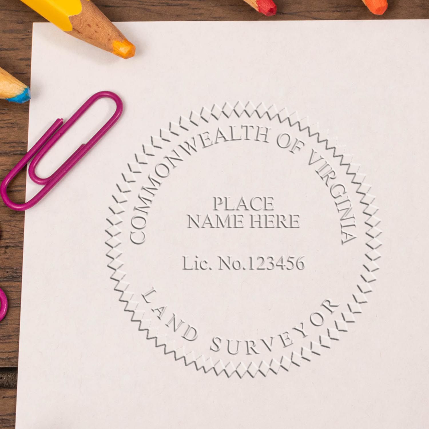 An alternative view of the Heavy Duty Cast Iron Virginia Land Surveyor Seal Embosser stamped on a sheet of paper showing the image in use