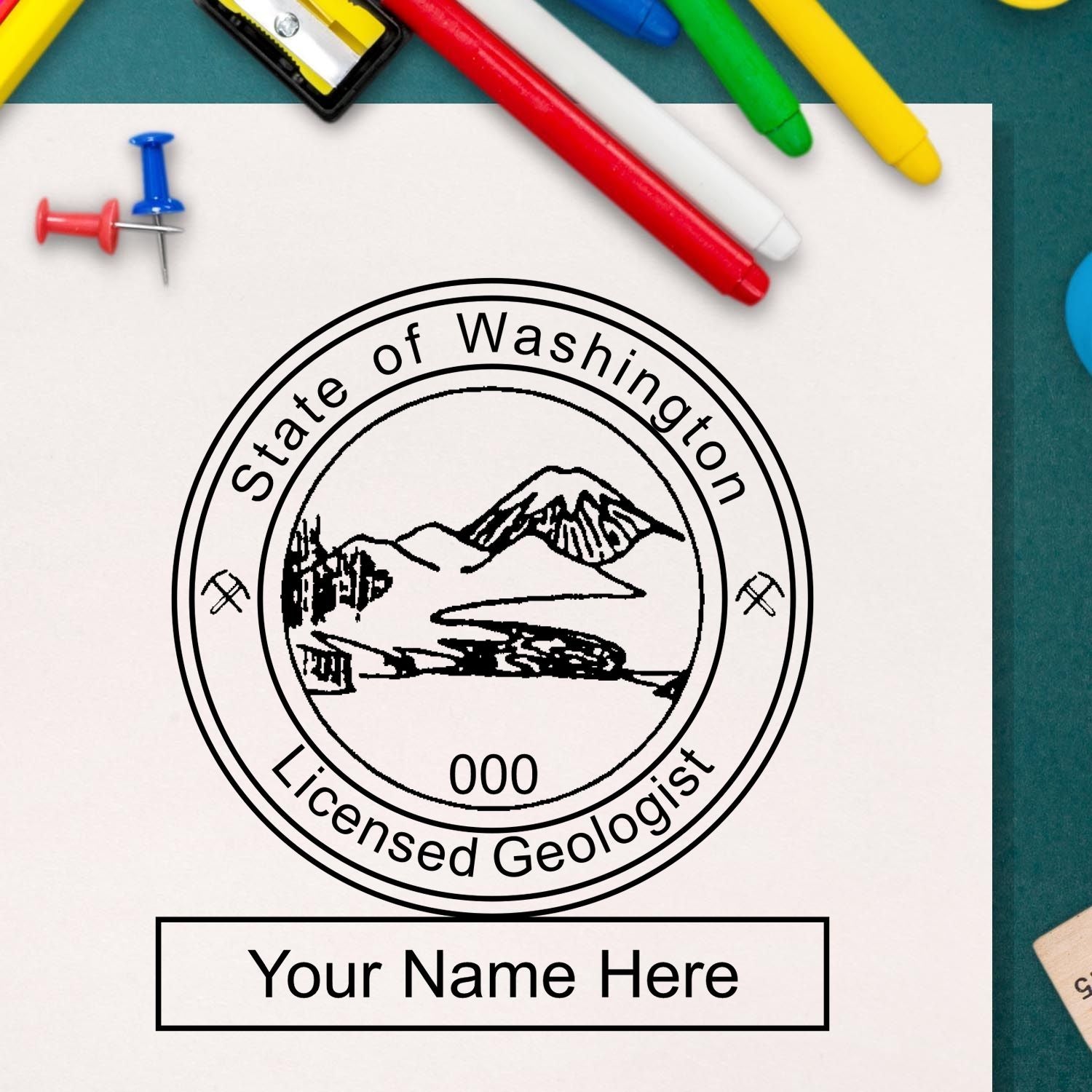 A lifestyle photo showing a stamped image of the Slim Pre-Inked Washington Professional Geologist Seal Stamp on a piece of paper