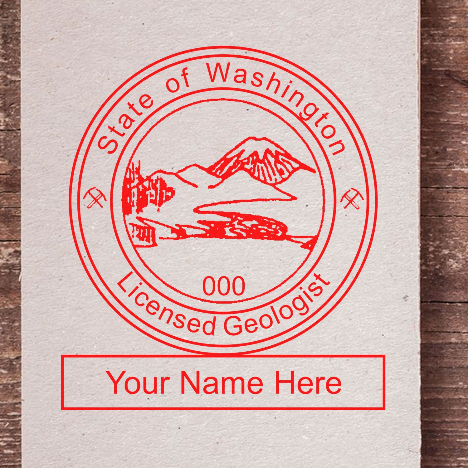 An in use photo of the Washington Professional Geologist Seal Stamp showing a sample imprint on a cardstock