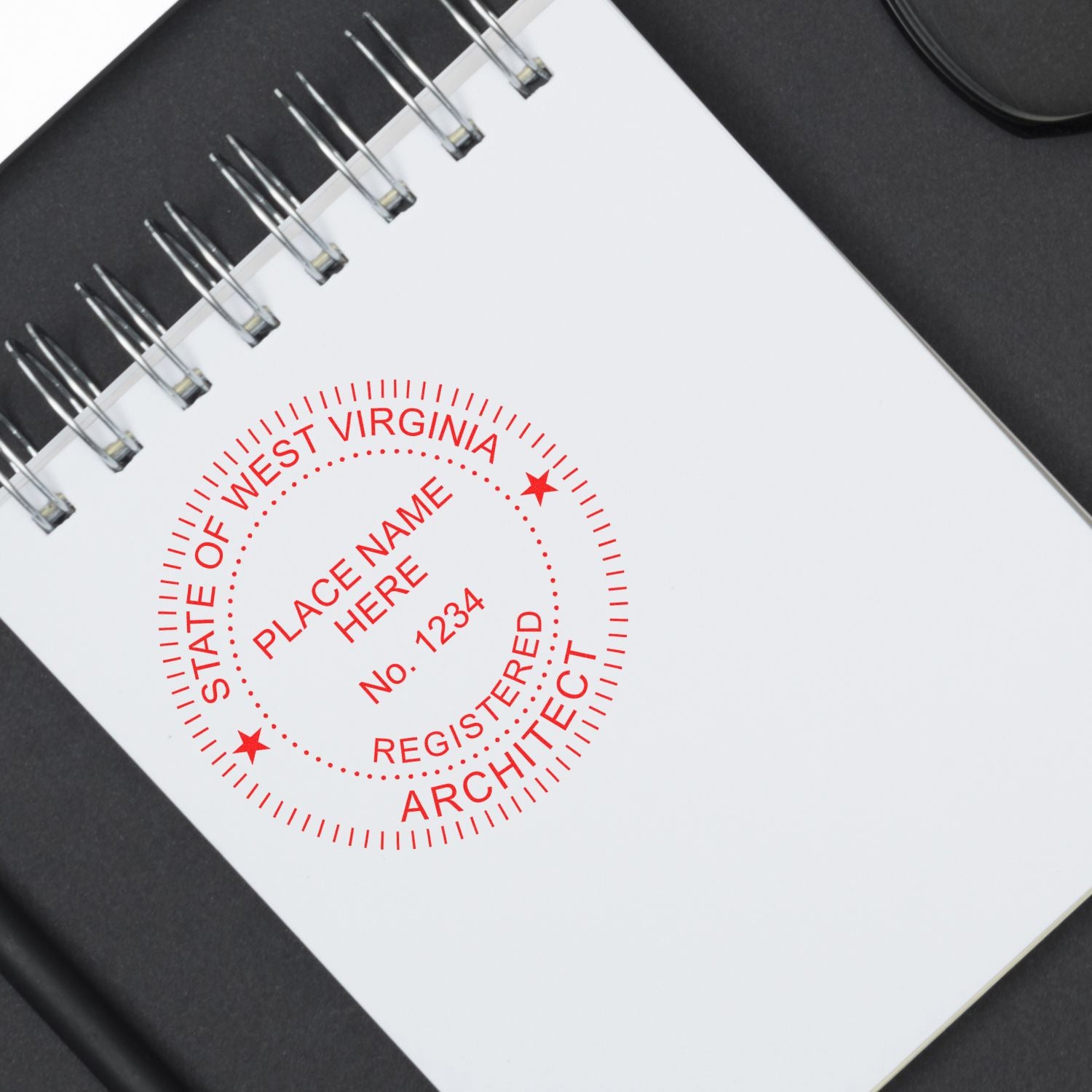 Premium MaxLight Pre-Inked West Virginia Architectural Stamp in red ink on a white notepad, placed on a black surface.