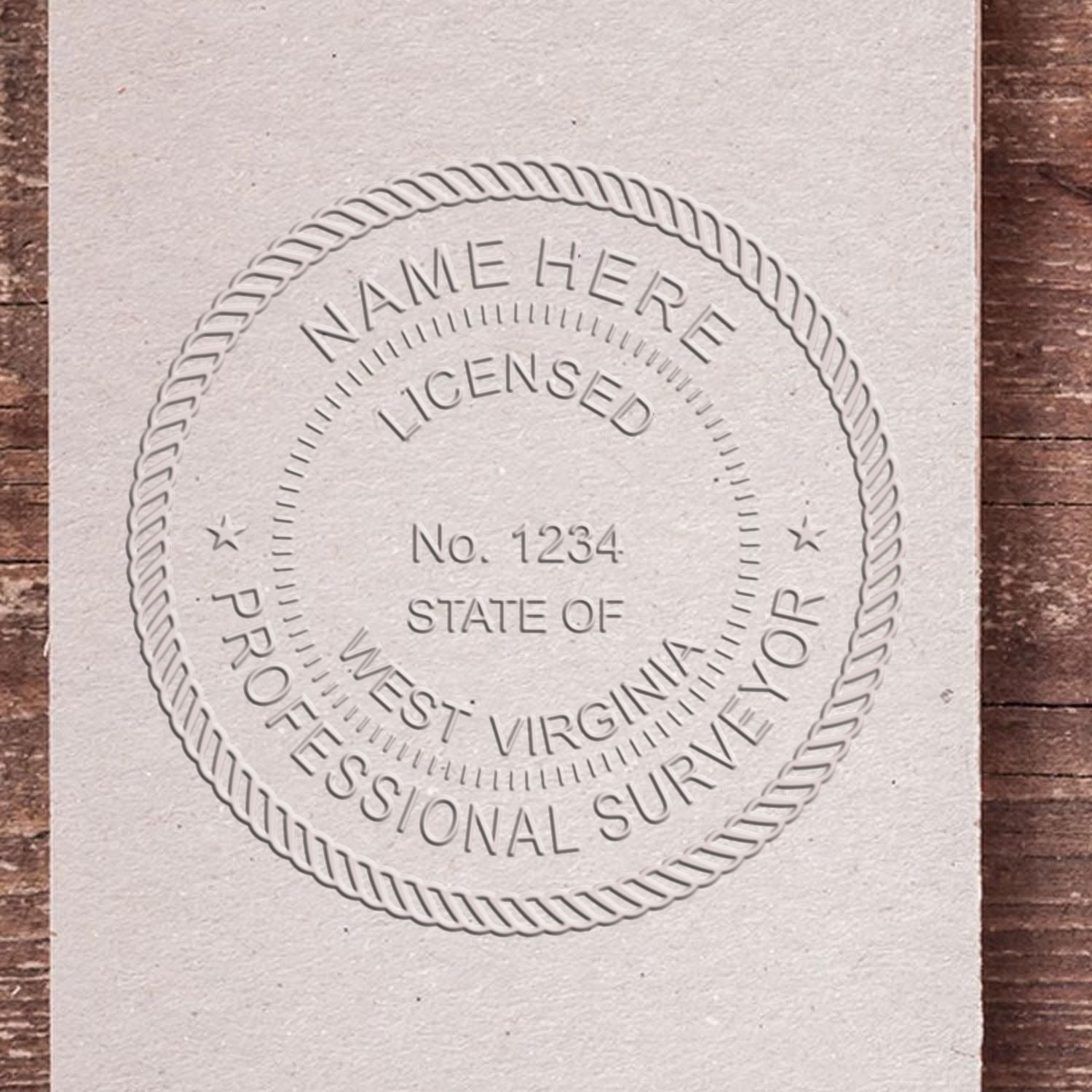 Another Example of a stamped impression of the Heavy Duty Cast Iron West Virginia Land Surveyor Seal Embosser on a piece of office paper.