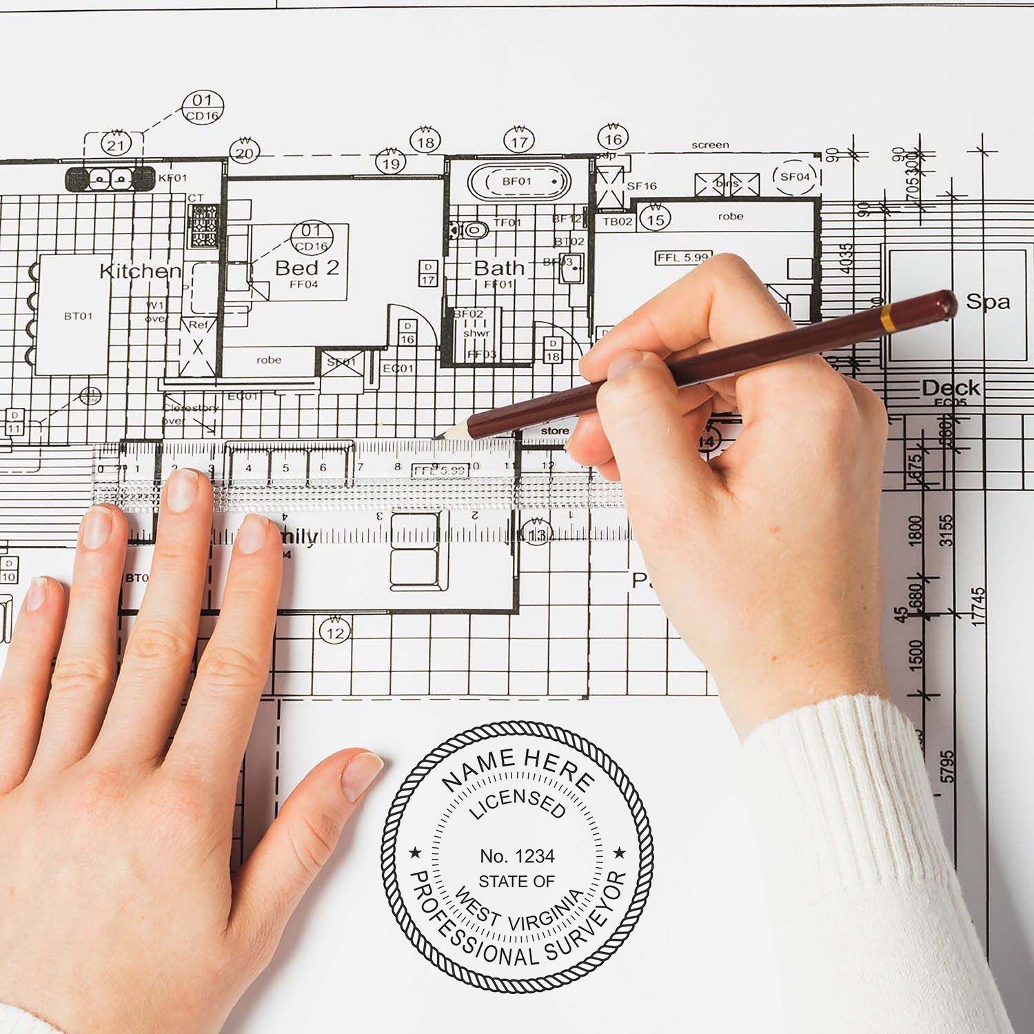 Person using Premium MaxLight Pre-Inked West Virginia Surveyors Stamp on architectural blueprint with detailed floor plan.