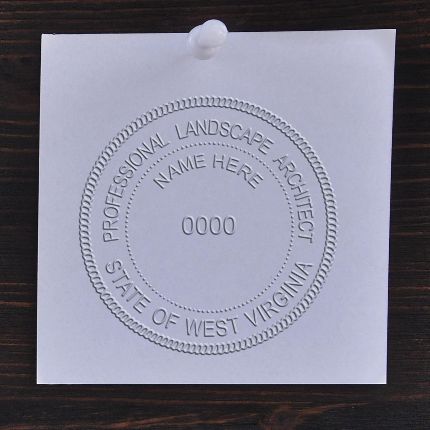 A stamped impression of the State of West Virginia Handheld Landscape Architect Seal in this stylish lifestyle photo, setting the tone for a unique and personalized product.