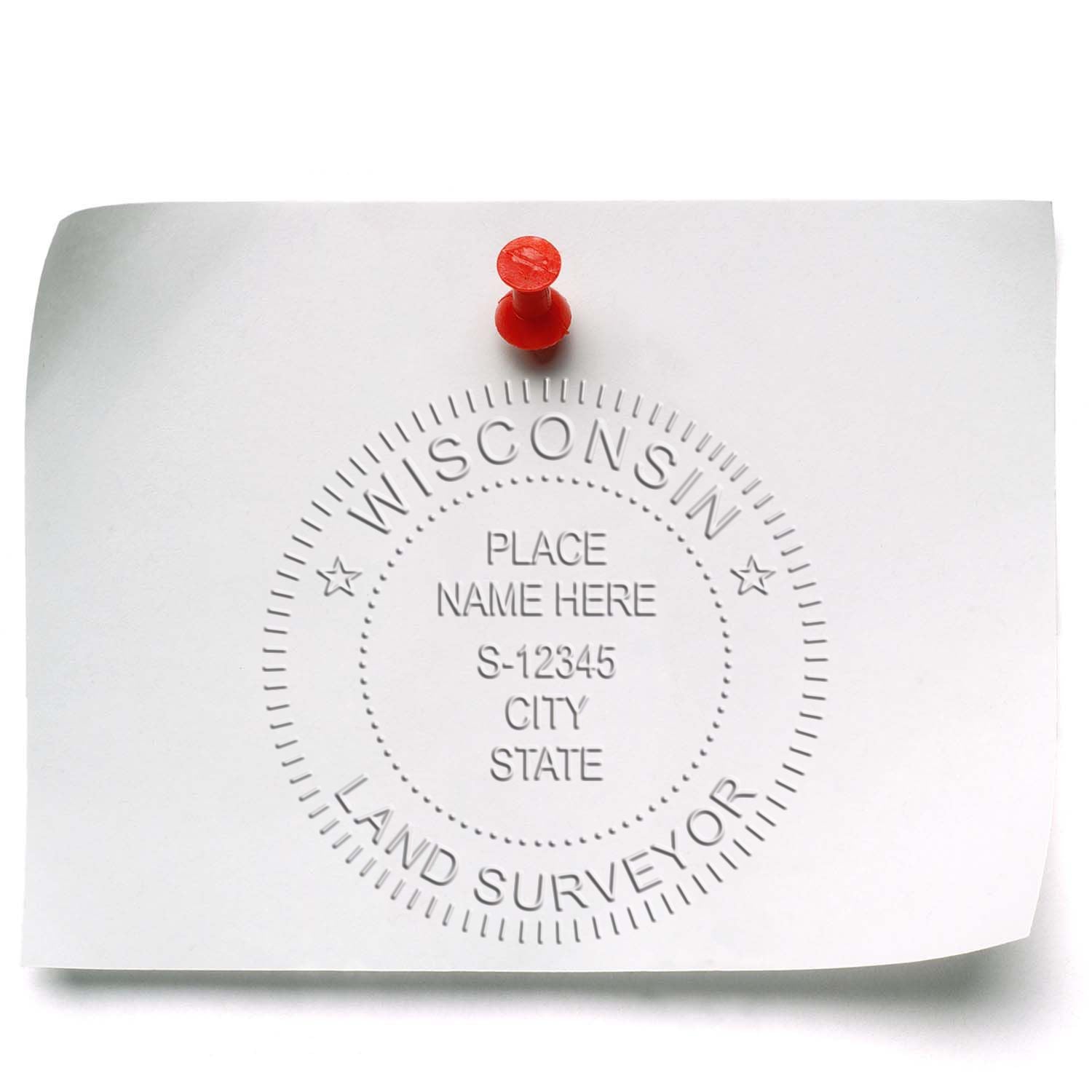 Image of a white paper embossed with a Wisconsin Land Surveyor Desk Seal Embosser, pinned to a board with a red pushpin.