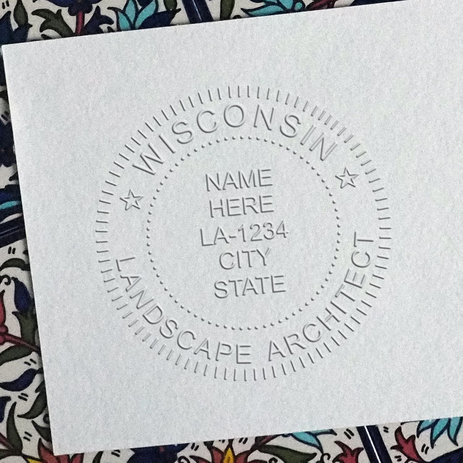 A stamped impression of the State of Wisconsin Handheld Landscape Architect Seal in this stylish lifestyle photo, setting the tone for a unique and personalized product.