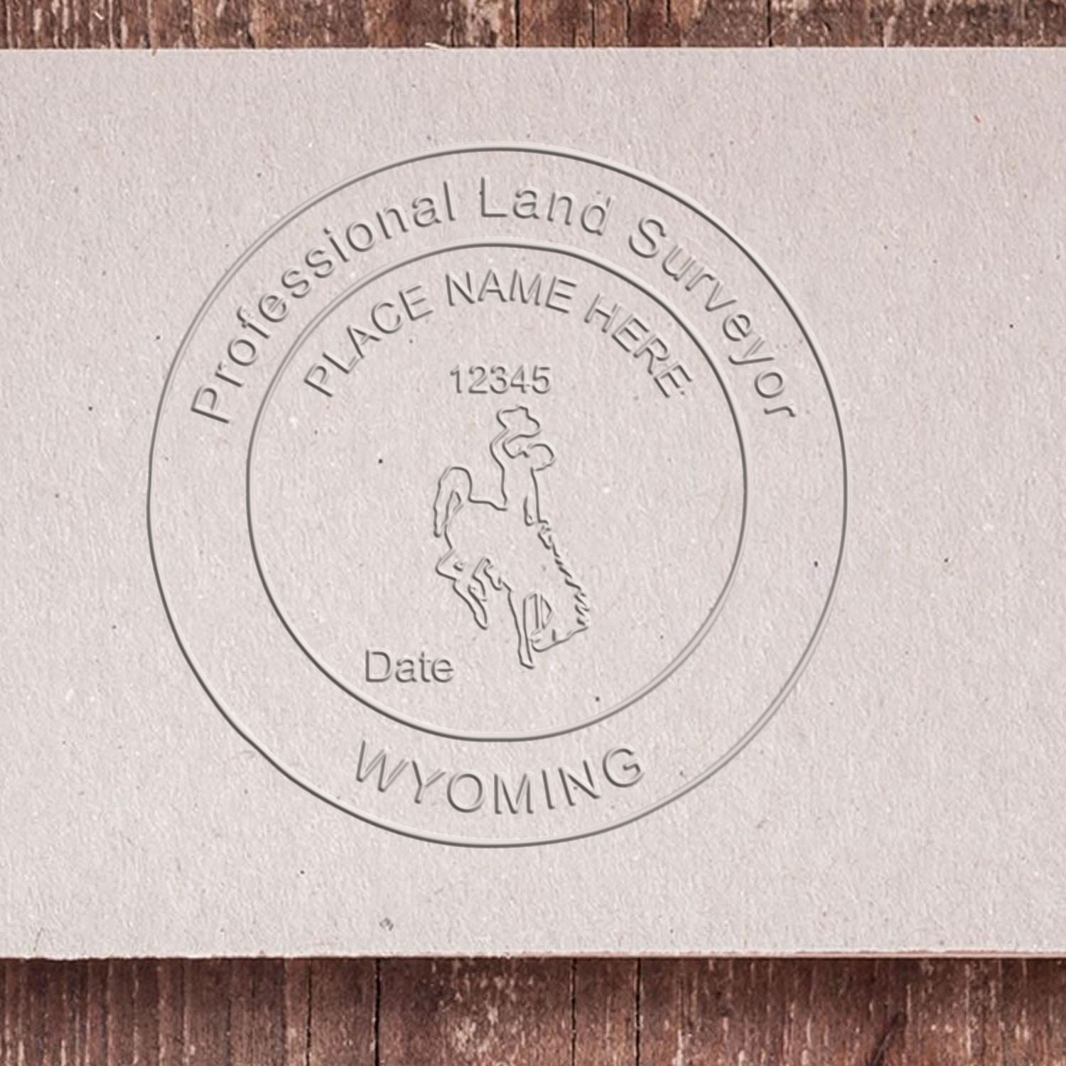 A lifestyle photo showing a stamped image of the State of Wyoming Soft Land Surveyor Embossing Seal on a piece of paper