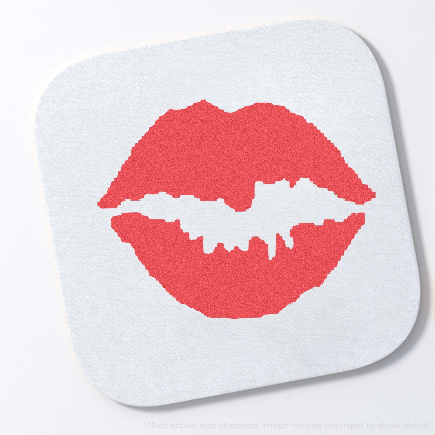 Round Kiss Xstamper Stamp imprint of red lips on a white surface.