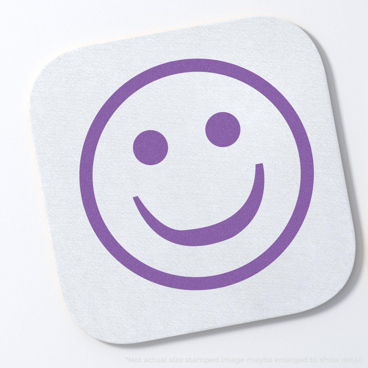 Round Violet Smiley Face Xstamper Stamp imprint on a white square paper, showing a purple smiley face with two dots for eyes and a curved smile.